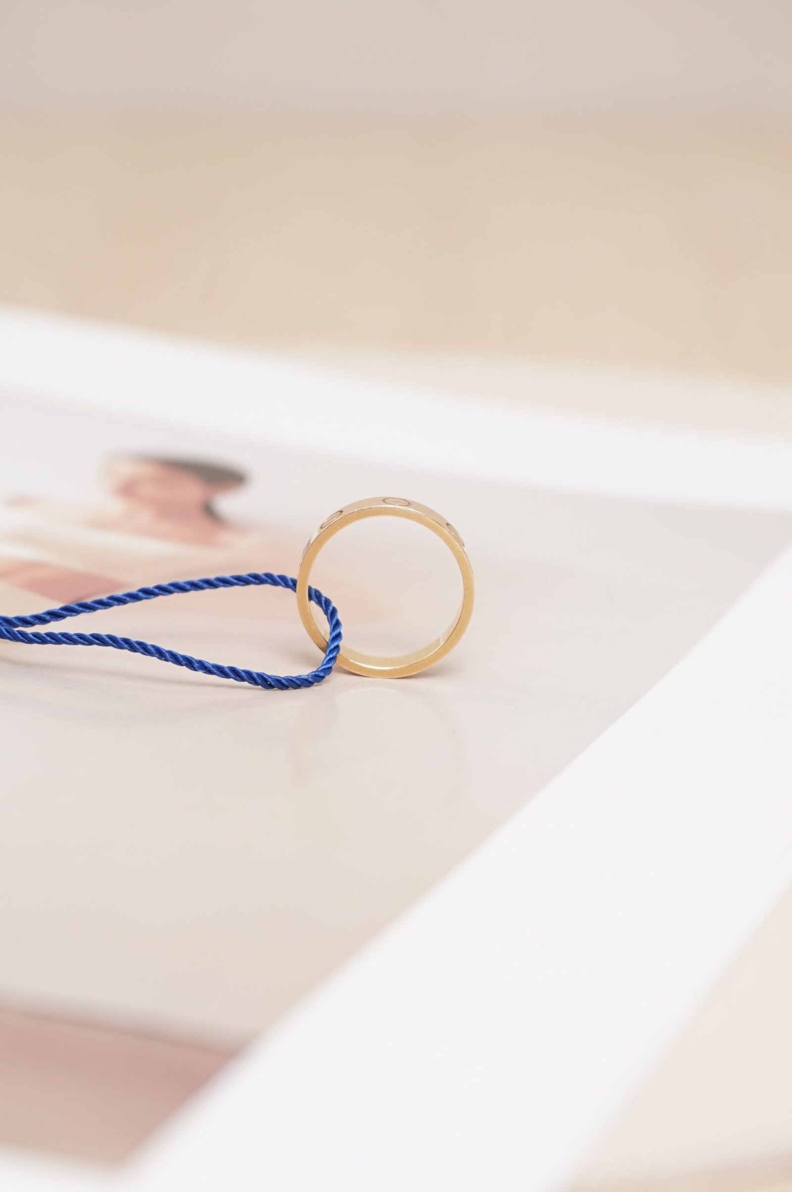 Close-up photograph of a Cartier ring on a hand