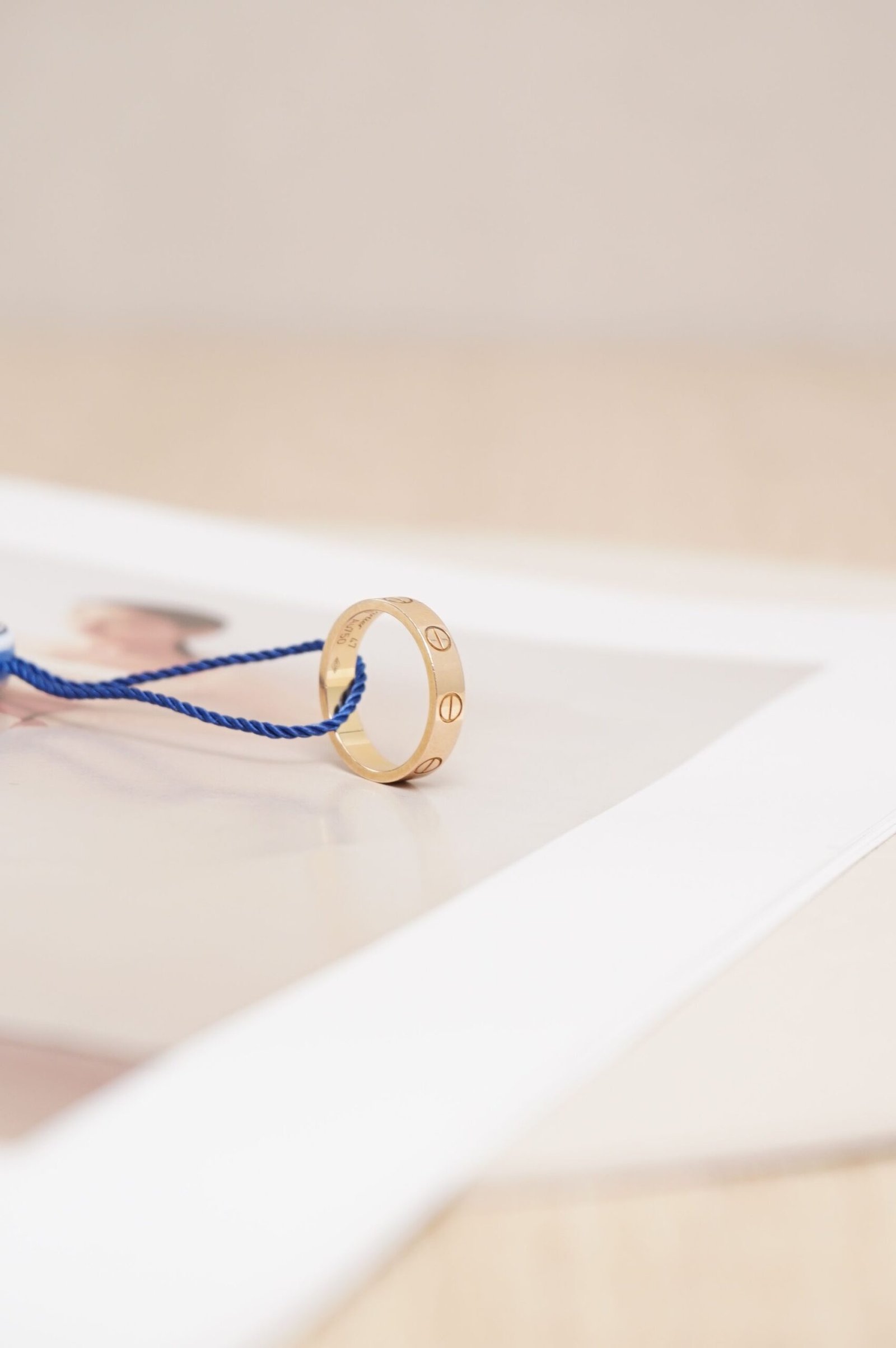 Close-up photograph of a Cartier ring on a hand