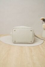 Close-up side view of a Hermès Picotin Lock 18 handbag in Nata Clemence leather with gold hardware and an ostrich leather han