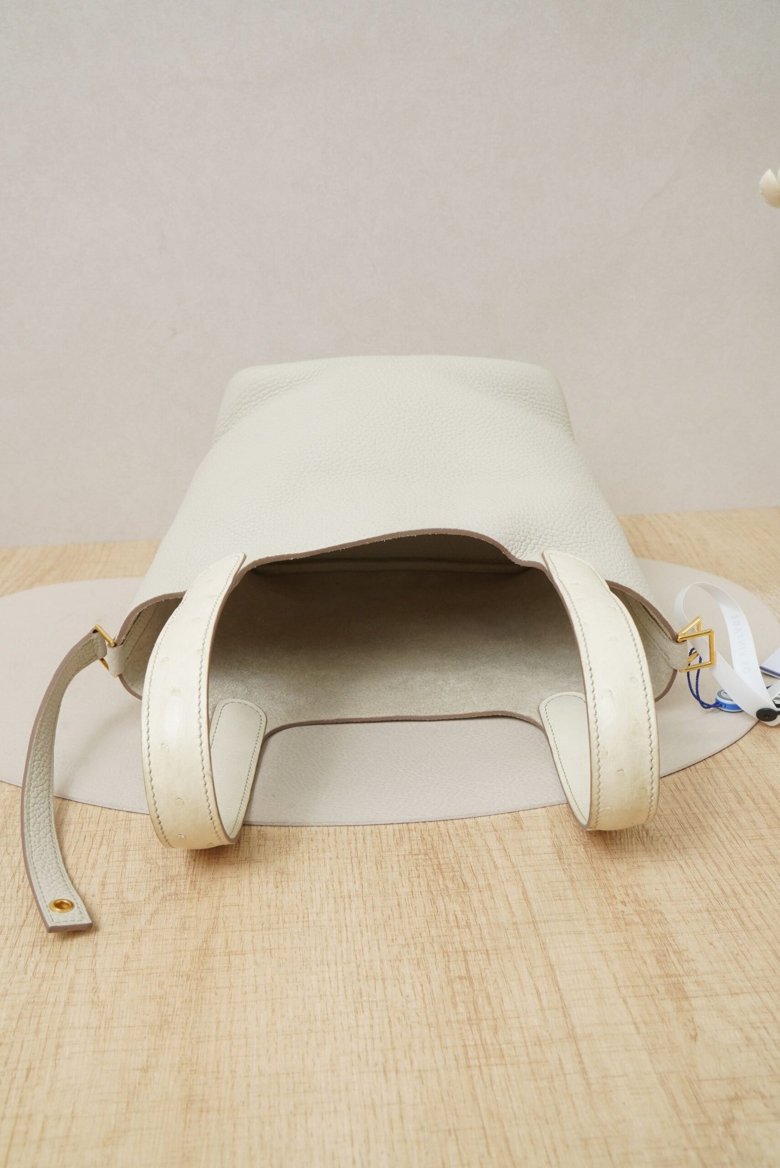 Close-up view of Hermès Picotin Lock 18 bag in Nata Clemence leather with gold hardware and ostrich leather handle